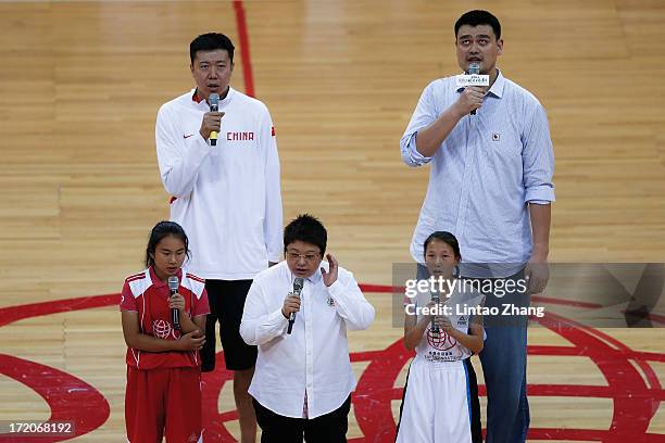 Former NBA star Yao Ming Sing the national anthem with Wang Zhizhi during the 2013 Yao Foundation Charity Game between China and the NBA Stars on...