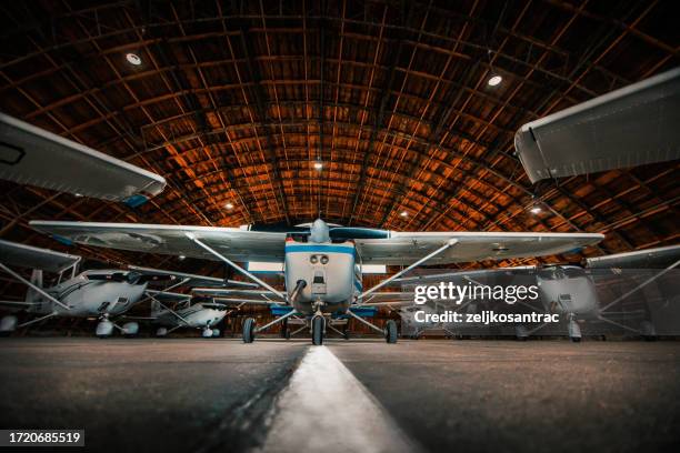 the plane in the hangar - propeller airplane stock pictures, royalty-free photos & images
