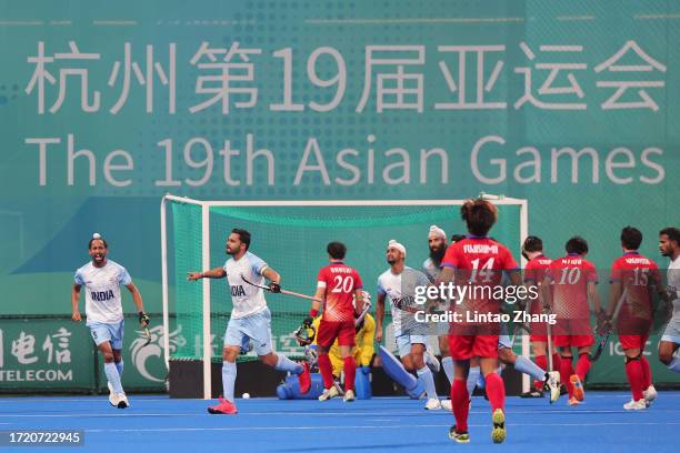 Harmanpreet Singh of India celebrate a goal with teammate during the Asian Games Men's Final Hockey event match between Japan and India at Gongshu...