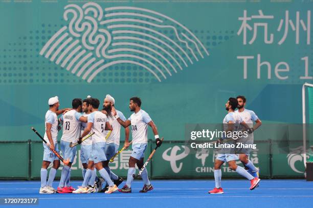 Harmanpreet Singh of India celebrate a goal with teammate during the Asian Games Men's Final Hockey event match between Japan and India at Gongshu...
