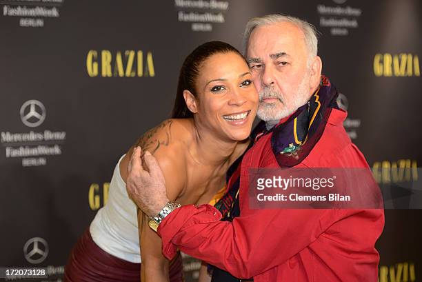 Annabelle Mandeng and Udo Walz attend the Mercedes-Benz Fashion Week Berlin Spring/Summer 2014 Preview Show by Grazia at the Brandenburg Gate on July...