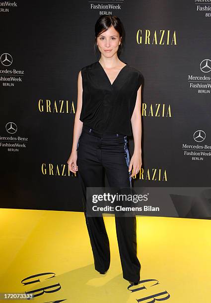 Aylin Tezel attends the Mercedes-Benz Fashion Week Berlin Spring/Summer 2014 Preview Show by Grazia at the Brandenburg Gate on July 1, 2013 in...