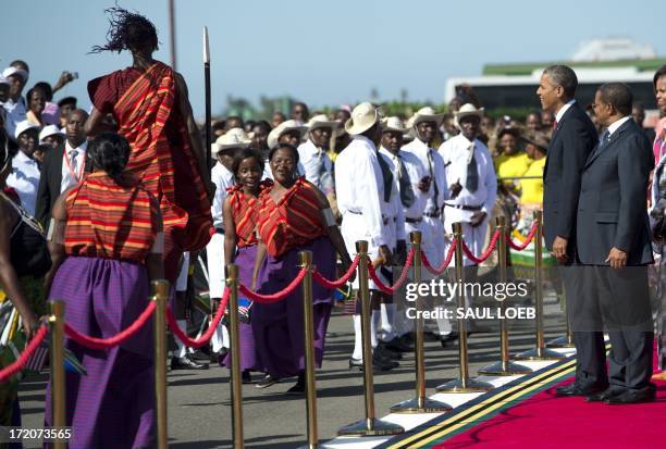 Tanzanian President Jakaya Kikwete and US President Barack Obama watch dancers on July 1, 2013 upon the latter's arrival on Air Force One at the...