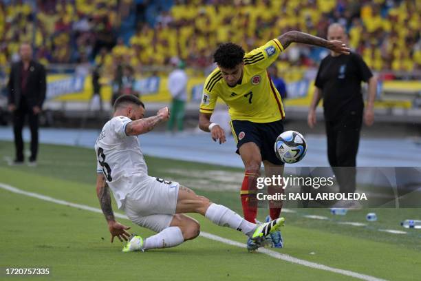 Uruguay's midfielder Nahitan Nandez challenges Colombia's forward Luis Diaz during the 2026 FIFA World Cup South American qualification football...