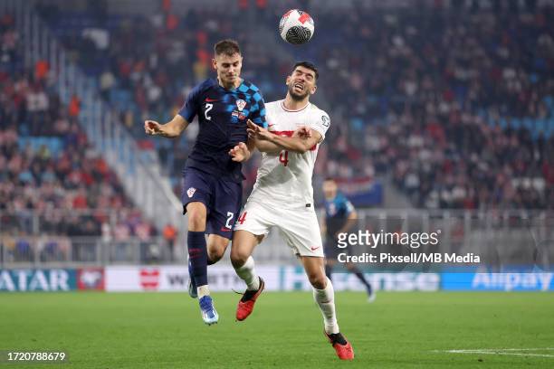 Josip Stanisic of Croatia and Cenk Ozkacar of Turkiye jumping for a ball during the UEFA EURO 2024 European qualifier match between Croatia and...