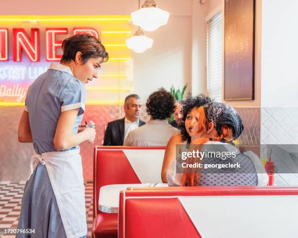 taking an order from diner customers - waitress booth stock pictures, royalty-free photos & images