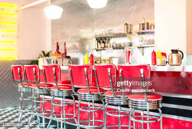 red stools at the cafe counter - vintage restaurant interior stock pictures, royalty-free photos & images