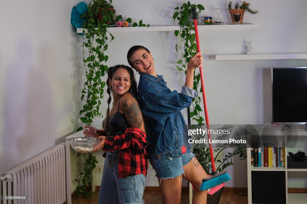 Medium shot portrait of a young beautiful and confident latino women joking and tidying up during a post party