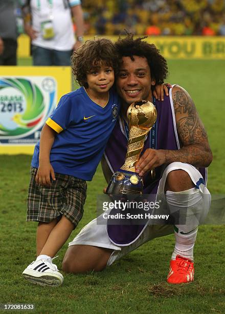 Marcelo of Brazil poses with his son and the trophy at the end of the FIFA Confederations Cup Brazil 2013 Final match between Brazil and Spain at...