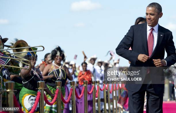 President Barack Obama dances to music upon arrival on Air Force One at Julius Nyerere International Airport in Dar Es Salaam, Tanzania, on July 1,...