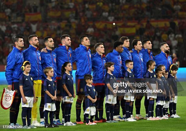 Spain´s players pose with children wearing ear protection to draw attention on action taken to help children with autism prior the EURO 2024 first...