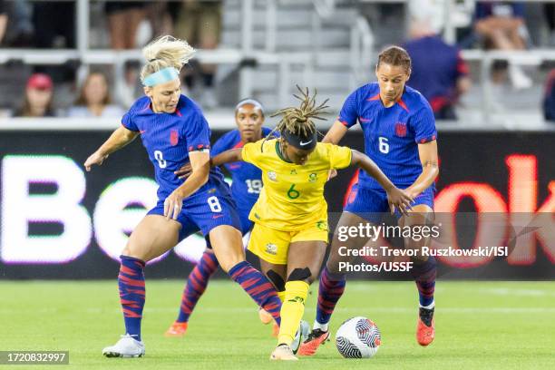 Noxolo Cesane of South Africa dribbles the ball while Julie Ertz of the United States and Lynn Williams of the United States defend in the game at...