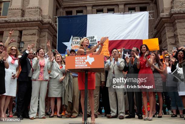 Texas Sen. Wendy Davis is surrounded by supporting Texas representatives and senators after leading a rally in support of Texas women's right to...