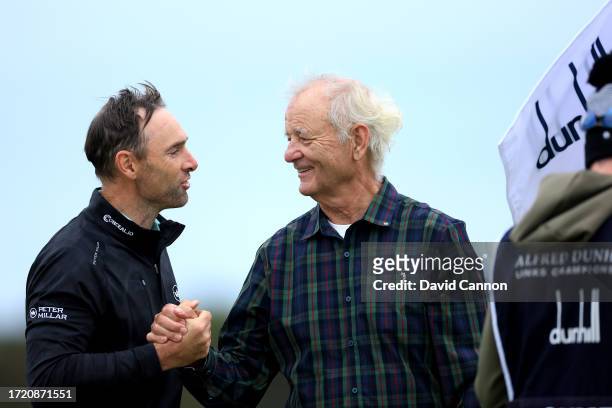 Oliver Wilson of England shakes hands with his amateur partner American actor Bill Murray on the ninth hole during Day Two of the Alfred Dunhill...