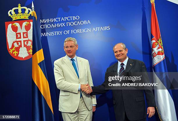 Serbian Minister of Foreign Affairs Ivan Mrkic shakes hands with his Swedish counterpart Carl Bildt prior to their meeting in Belgrade on July 1,...