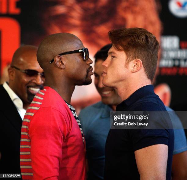 Floyd Mayweather and Canelo Alvarez square off during a press conference to discuss their Super Welterweight World Championship fight July 1, 2013 at...