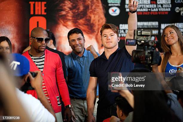 Floyd Mayweather and Canelo Alvarez square off during a press conference to discuss their Super Welterweight World Championship fight July 1, 2013 at...