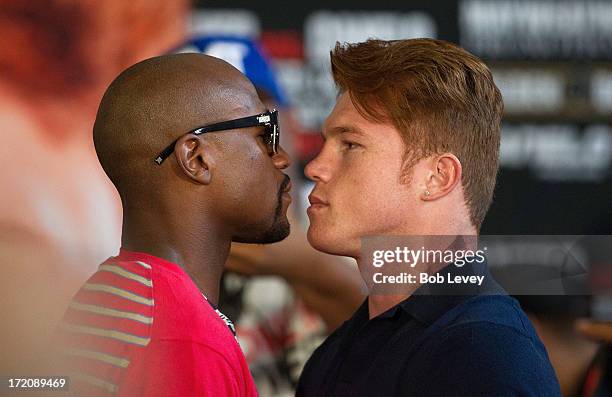 Floyd Mayweather and Canelo Alvarez square off during a press conference to discuss their Super Welterweight World Championship July 1, 2013 at Union...