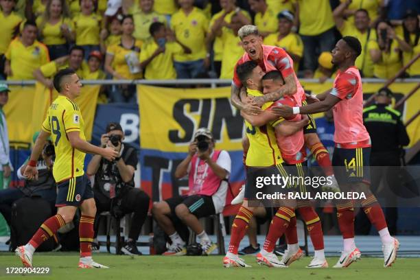 Colombia's midfielder Matheus Uribe celebrates with teammates after scoring his team's second goal during the 2026 FIFA World Cup South American...