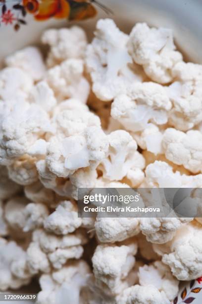 fresh cauliflower divided into pieces, close-up - cauliflower stock pictures, royalty-free photos & images
