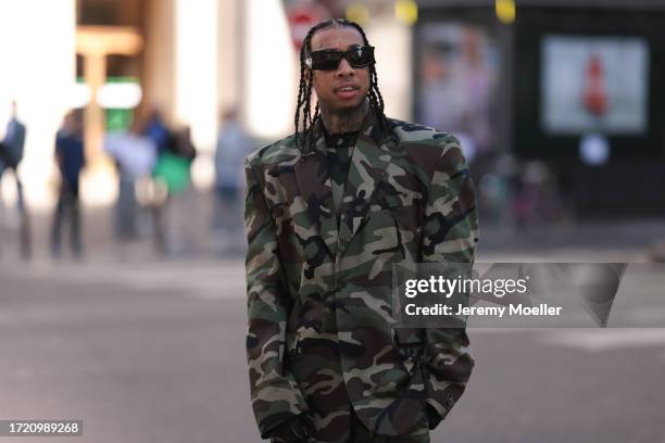 Tyga is seen wearing black Balenciaga shades and a army-like Vetements look including trousers and a jacket before the Ottolinger Fashion Show during...