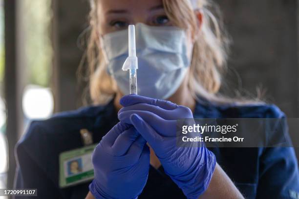 Pasadena, CA Tracy Gage, LVN, prepares a syringe at a flu and COVID vaccination clinic Kaiser Permanente Pasadena on Thursday, Oct. 12 in Pasadena,...