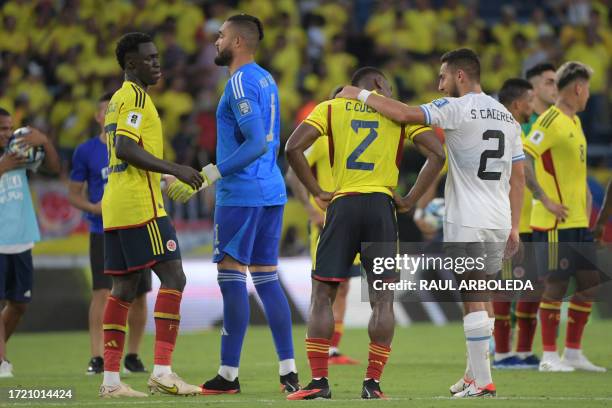 Colombia's defender Davinson Sanchez and goalkeeper Alvaro Montero, and Colombia's defender Carlos Cuesta and Uruguay's defender Sebastian Caceres...