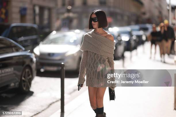 Alexandra Guerain is seen wearing black heels, black shades, a black bag and a brown-beige one-piecer bodysuit with collar and one open shoulder...