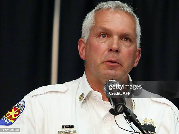 Prescott Fire Department Battalion Chief Don Devendorf cries as he speaks during the Yarnell fire memorial service held at Embry-Riddle Aeronautical...