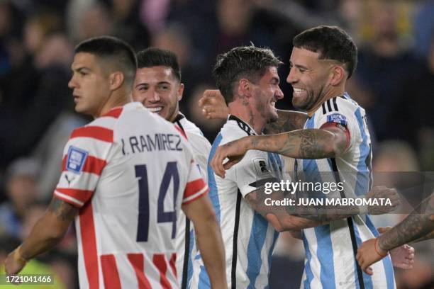 Argentina's defender Nicolas Otamendi celebrates with Argentina's midfielder Rodrigo De Paul after scoring his team's first goal during the 2026 FIFA...