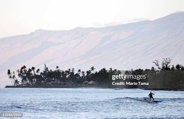 Person uses a stand-up paddle board off Launiupoko Beach Park, located south of Lahaina town center, on October 6, 2023 near Lahaina, Hawaii. The...