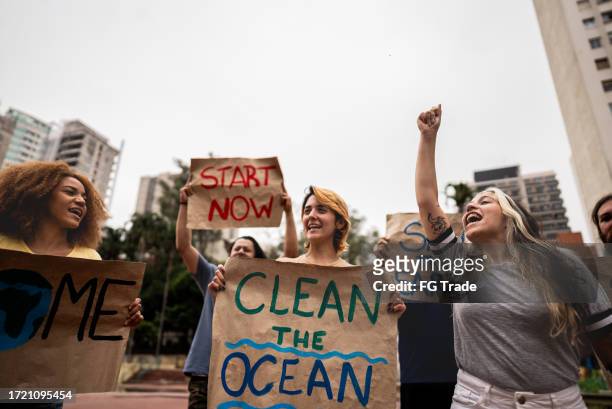 environmentalists protesting at city street - climate change global warming stock pictures, royalty-free photos & images