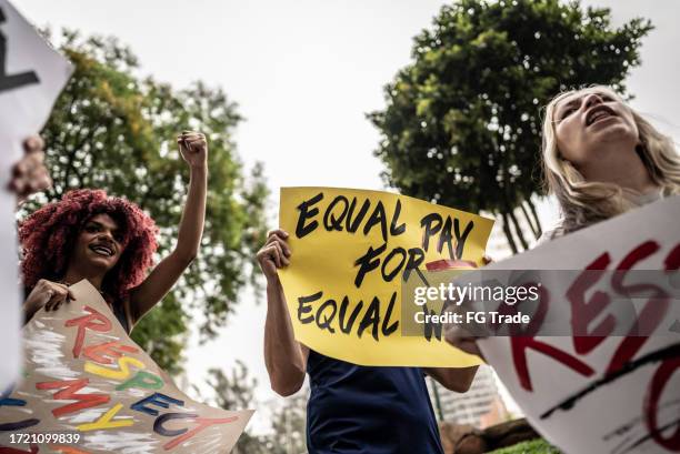 people protesting in the street - marching stock pictures, royalty-free photos & images