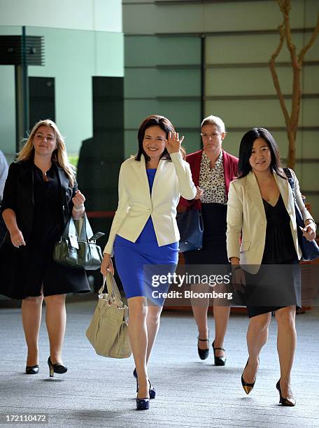 Sheryl Sandberg, chief operating officer of Facebook Inc., center, waves as she arrives at the Japanese Prime Minister's official residence before...