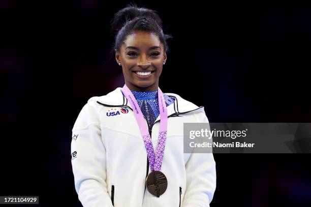 Gold medalist Simone Biles of Team United States reacts during the medal ceremony for the Women's All Around Final on Day Seven of the 2023 Artistic...
