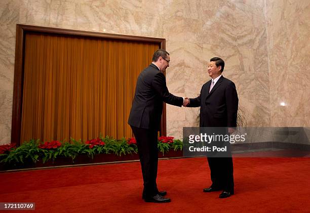 Romanian Prime Minister Victor-Viorel Ponta is greeted by Chinese President Xi Jinping upon arrival for a meeting at the Great Hall of the People on...