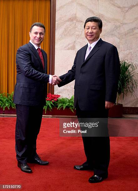 Macedonian Prime Minister Nikola Gruevski shakes hands with Chinese President Xi Jinping upon arrival for a meeting at the Great Hall of the People...