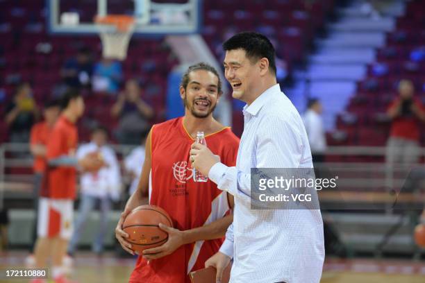 Joakim Noah of Chicago Bulls talks with Yao Ming during the 2013 Yao Foundation Charity Game between China and the NBA Stars at MasterCard Center on...