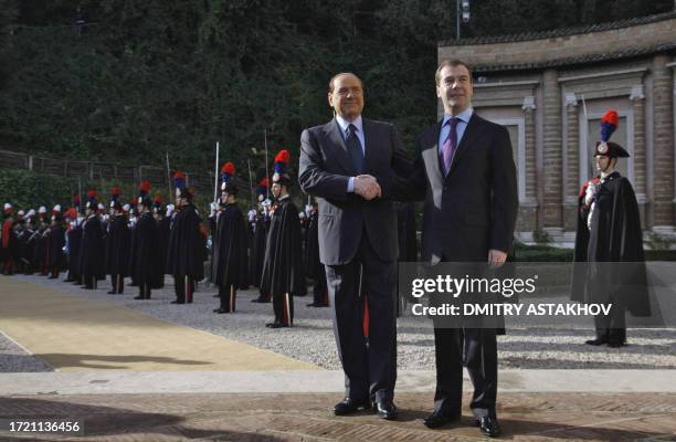 Russian President Dmitry Medvedev shakes hands with Italian Prime Minister Silvio Berlusconi at Villa Madama in Rome on December 3, 2009. Medvedev is...