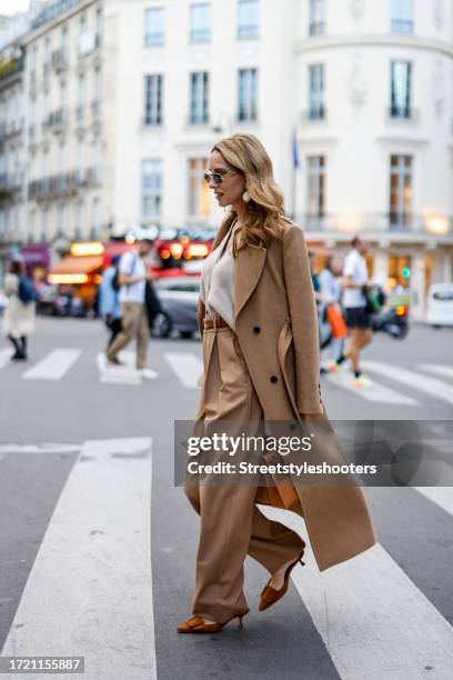 Influencer Alexandra Lapp, wearing Karen Millen double breasted coat in camel, Rossi wide legged pants Noa in camel, an Allude knit cardigan in...