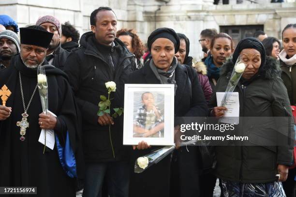 People Hold Photos And Flowers As They Leave After The Grenfell Tower National Memorial Service At St Paul'S Cathedral In London, To Mark The Six...