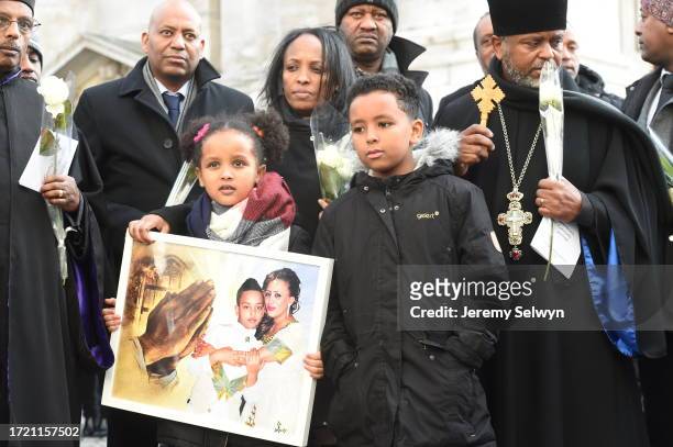 People Hold Photos And Flowers As They Leave After The Grenfell Tower National Memorial Service At St Paul'S Cathedral In London, To Mark The Six...