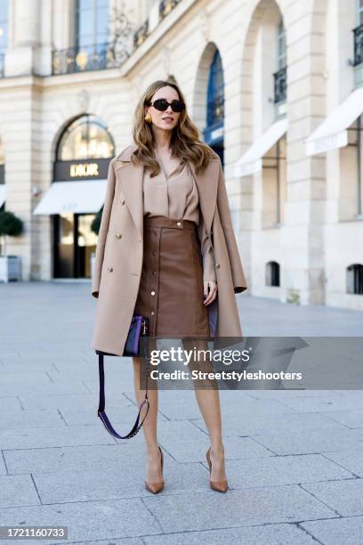 Influencer Alexandra Lapp, wearing a Joop leather skirt in brown, a Joop jacket and blouse in beige, Christian Louboutin heels in beige, Celine...