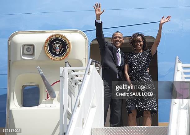 President Barack Obama and First Lady Michelle Obama board Air Force One upon departure at Julius Nyerere International Airport in Dar Es Salaam,...