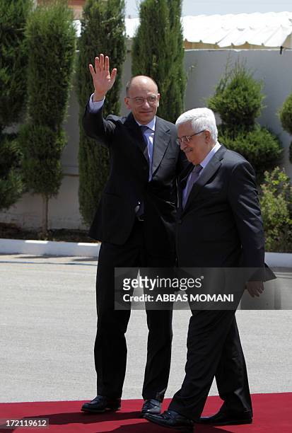 Italian Prime Minister Enrico Letta waves to the press upon his arrival in the West Bank city of Ramallah, ahead of his meeting with Palestinian...