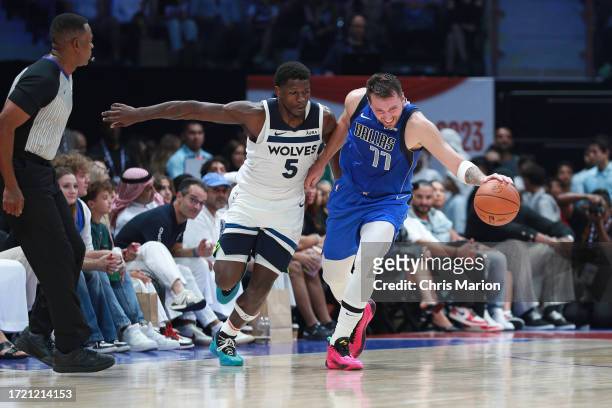 Luka Doncic of the Dallas Mavericks and Anthony Edwards of the Minnesota Timberwolves fight for the ball during the Dallas Mavericks game against the...