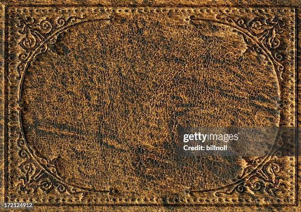 old leather bookcover with engraved scroll pattern - western borders stock pictures, royalty-free photos & images