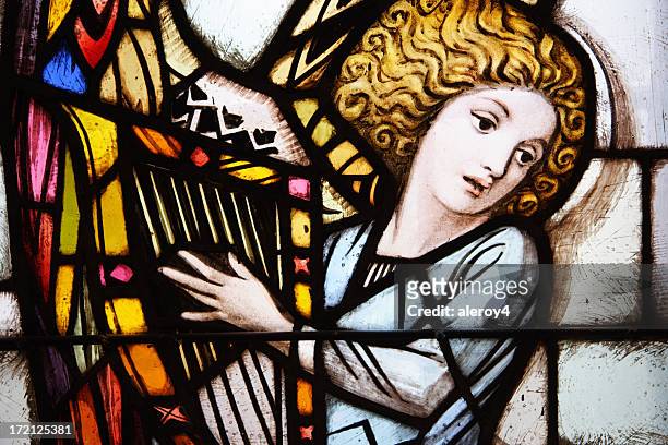 stained glass window of angel playing the harp - stained glass angel stock pictures, royalty-free photos & images