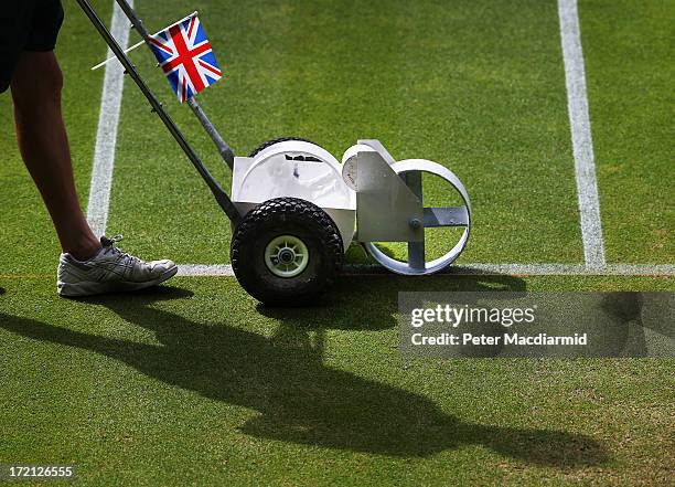 Groundsman paints the white lines on the grass of Centre Court at the Wimbledon Lawn Tennis Championships on July 1, 2013 in London, England. The...