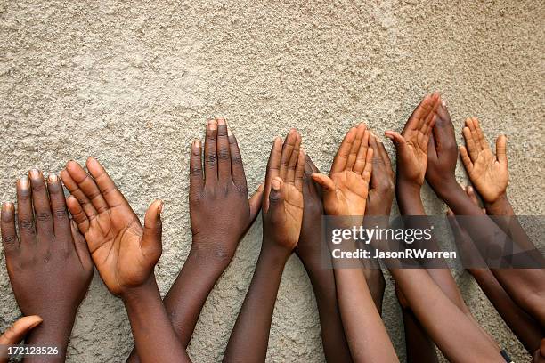 hopefull hands - brown girl stock pictures, royalty-free photos & images